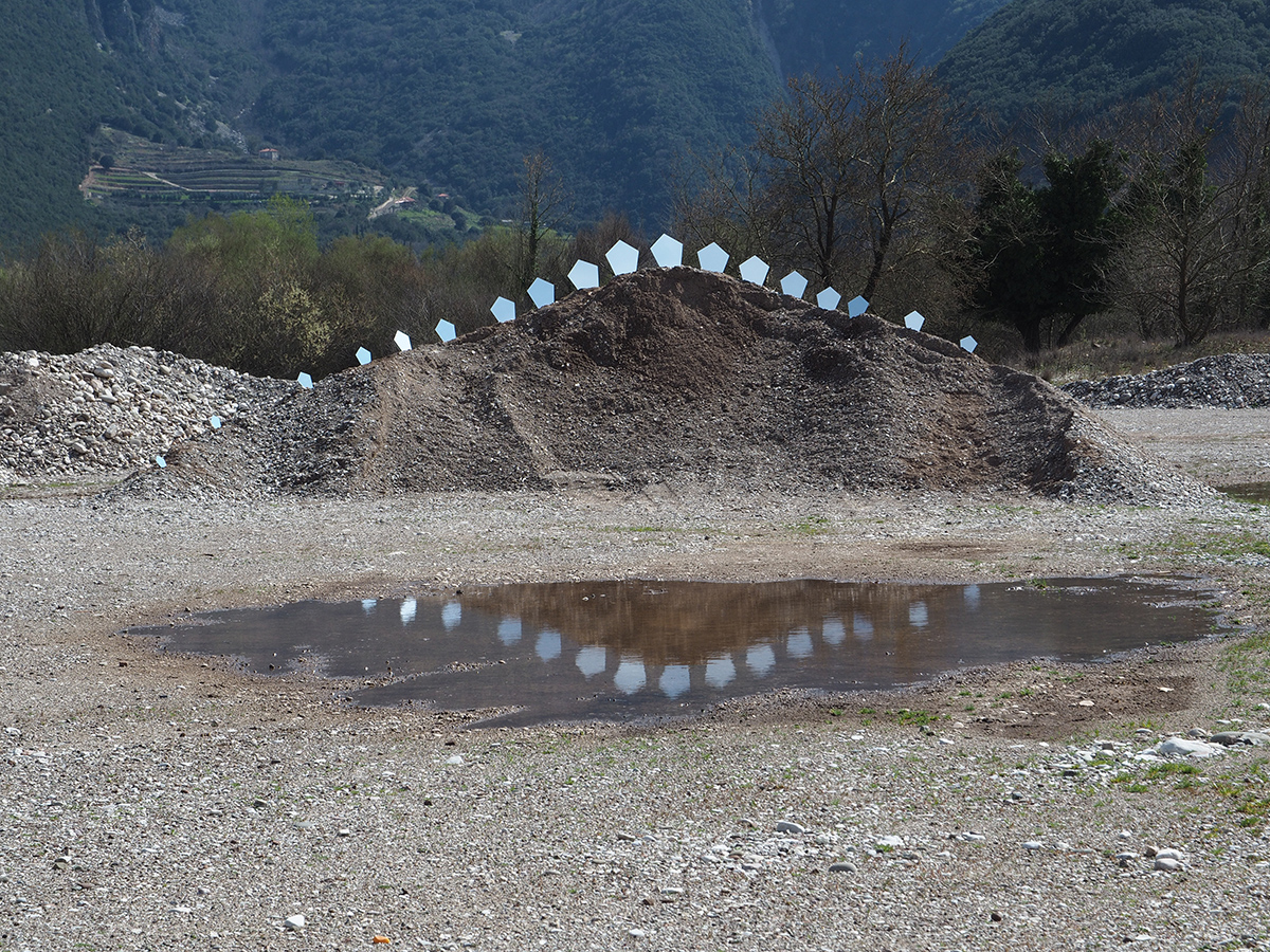 Land Art with mirrors on pile-Stegosaurus installation